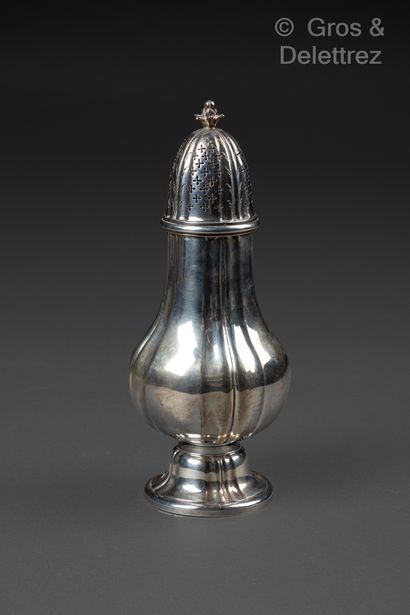 null A baluster-shaped silver sprinkler with pinched ribs resting on a pedestal....