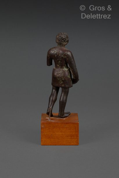 null Statuette of a bare-chested priest wearing a short loincloth tied with a knot...