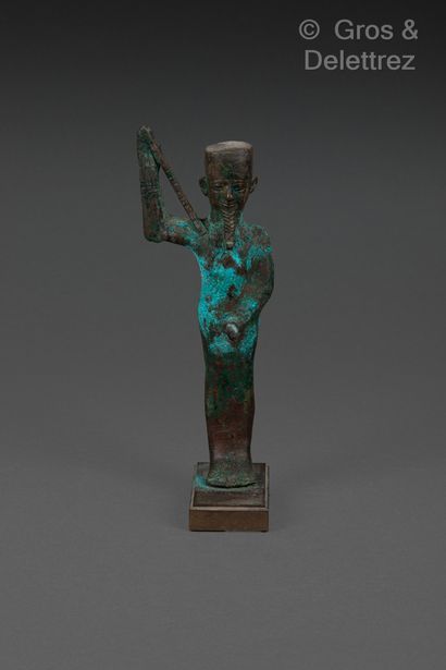 null Standing statue of the ithyphallic Minh god. His raised right arm holds a flagellum.
Bronze...