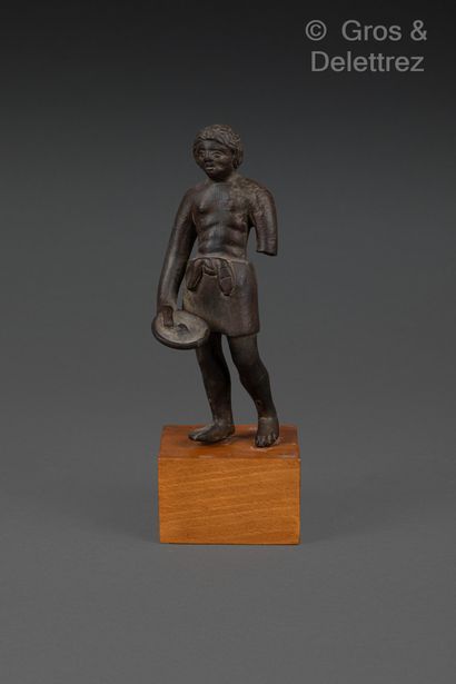 null Statuette of a bare-chested priest wearing a short loincloth tied with a knot...