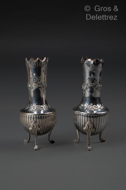 null A pair of silver baluster-shaped soliflora vases decorated with repoussé floral...