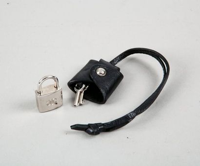 CHANEL Clochette en cuir noir comprenant deux clefs et un cadenas en métal argenté....