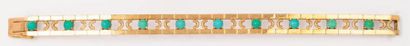 null Bracelet articulé en or jaune orné de cabochons de turquoises. P. 33,4g