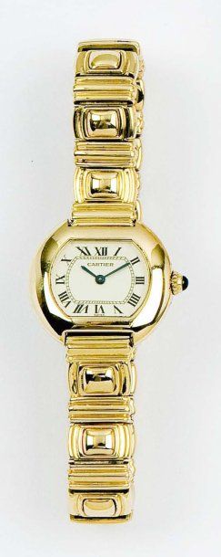 CARTIER Bracelet-montre de dame en or jaune, cadran champagne à chiffres romains,...