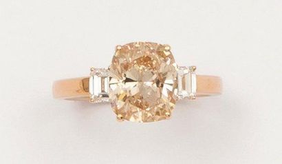 null Bague solitaire en or jaune ornée d'un diamant de taille coussin épaulé de deux...