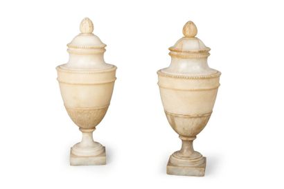 null Paire de vases couverts sur piédouche, en forme d'urnes, en albâtre mouluré...