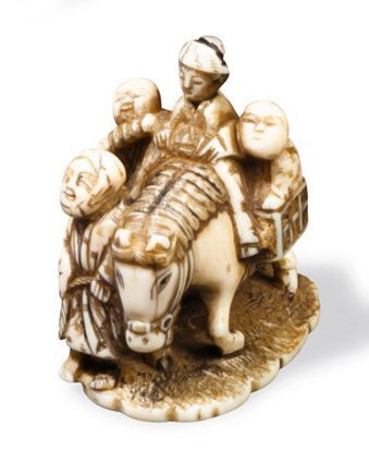 null Netsuke en ivoire représentant une jeune femme, un cheval et trois enfants.Japon,...