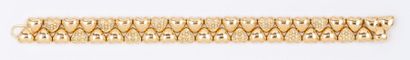 CARTIER Bracelet souple en or jaune à motif de coeurs, certains pavés de diamants...