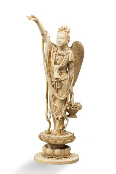 null Sujet en ivoire représentant une divinité féminine ailée tenant d'une main un...