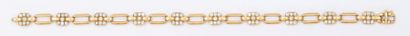 O.J. PERRIN Bracelet articulé en or jaune orné de motifs pavés de diamants taillés...