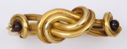 null Bracelet jonc ouvrant en or jaune ornée d’un motif d’un noeud serti de deux...