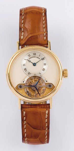 BREGUET - TOURBILLON. Montre de poignet en or jaune. Cadran guilloché laissant apparaitre...