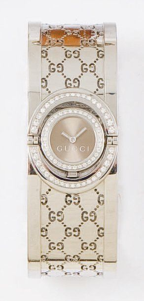 GUCCI : Bracelet montre de dame en acier. La lunette sertie de diamants. Mouvement...