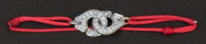 null DINH VAN « Menottes » - Bracelet sur cordon de soie rose orné de deux motifs...