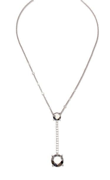 CHOPARD Chaîne et pendentif en or gris orné de deux motifs en or gris taillés à facettes...