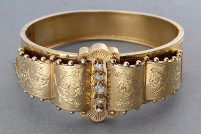  Bracelet rigide ouvrant en or jaune ciselé à décor floral orné, au centre, de cinq...
