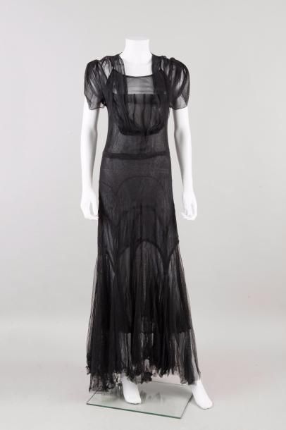 null Anonyme circa 1930

Robe longue du soir en tulle noir, effet de drapé et découpes,...