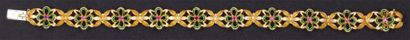 null Bracelet articulé en or jaune à décor floral ajouré émaillé vert orné de saphirs...