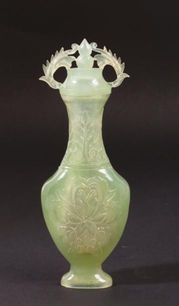 CHINE, XXe siècle 
Petit vase couvert en serpentine, à décor de fleurs de lotus....