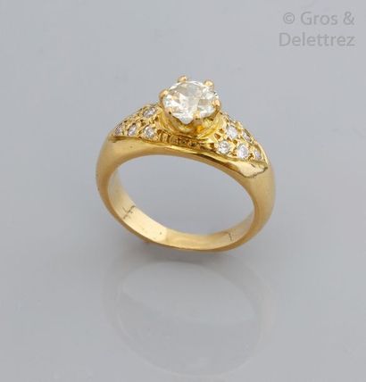 null Bague en or jaune ornée d'un diamant taillé en brillant épaulé de diamants plus...