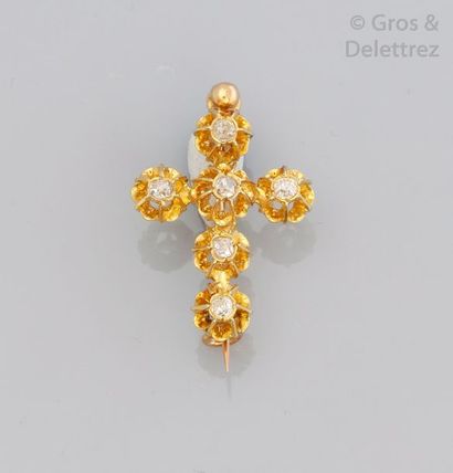 null Broche "croix" en or jaune ornée de diamants taillés en brillant. P. 2,8 g.