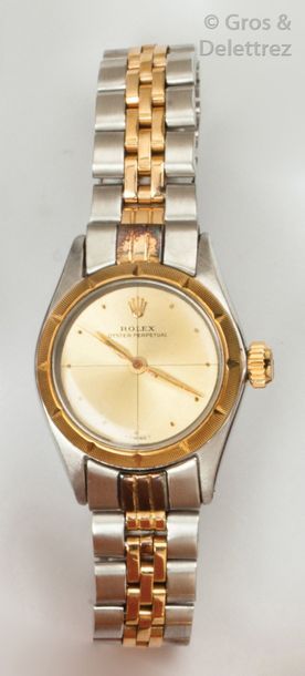 ROLEX Bracelet-montre de dame en or jaune et acier, cadran rond, cadran or, lunette...