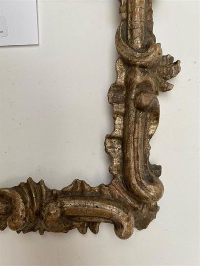 null CADRE en bois sculpté, argenté à décor d'agrafes, de rinceaux feuillagés dans...