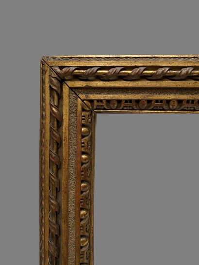 null carved and gilded wood frame decorated with interlacing, a twisted ribbon with...