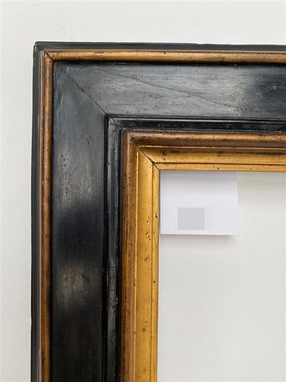 null Cassetta" frame with upside down profile in blackened and gilded wood.

Italy,...