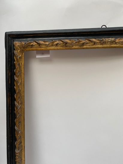 null Reverse profile frame in blackened and gilded wood, the rebate is twisted with...