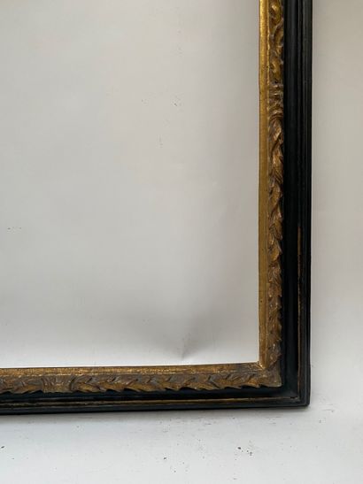 null Reverse profile frame in blackened and gilded wood, the rebate is twisted with...