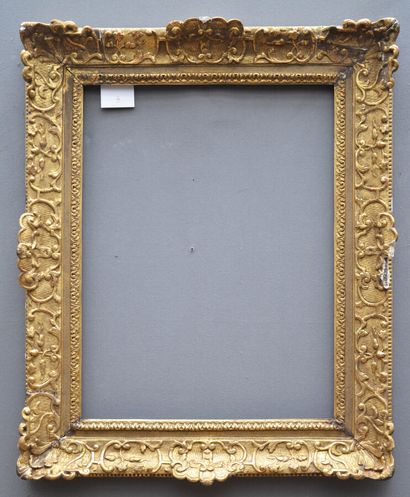 Carved and gilded oak frame with Bérain decor....