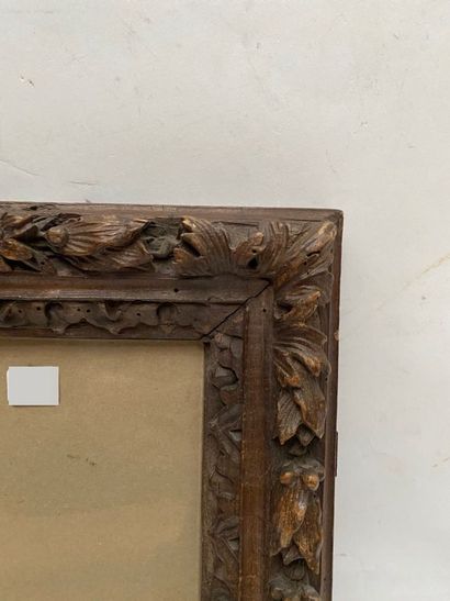 null FRAME in fruit wood, waxed and carved with a frieze of water leaves and laurel...
