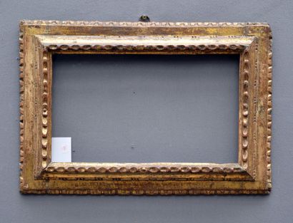 null Reverse profile carved and gilded wood frame with a frieze of laurel twists,...