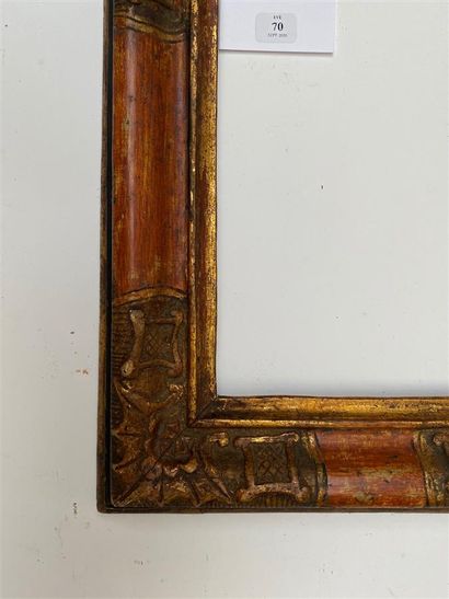 null Small FRAME in carved wood rechampi black, ochre and gold, the corners decorated...