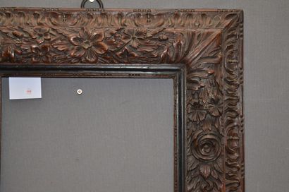 null FRAME with upside down profile in walnut carved with a frieze of rosaries, garland...