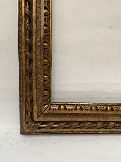 null carved and gilded wood frame decorated with interlacing, a twisted ribbon with...