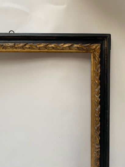 null Reverse profile frame in blackened and gilded wood, the rebate is twisted with...