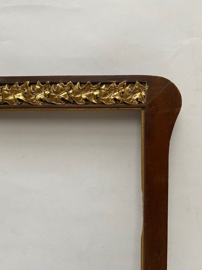 null FRAME in walnut with pediment decorated with a frieze of oak leaves centered...