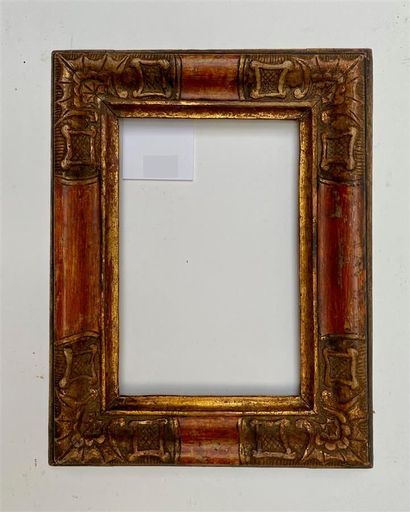 null Small FRAME in carved wood rechampi black, ochre and gold, the corners decorated...