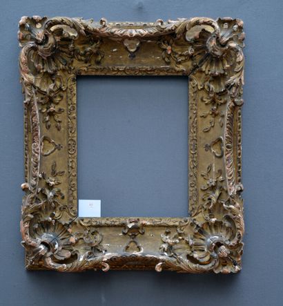 null Richly carved and gilded lindenwood frame with openwork decoration of a shell...