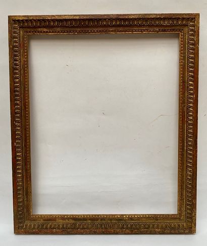 Carved and gilded wood frame with a frieze...