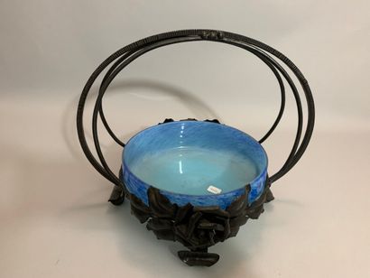 null A blue marbled glass circular bowl, set in a wrought iron frame with three handles,...