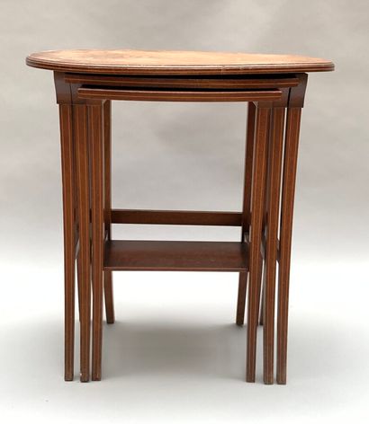 null Three nesting TABLES with oval top in veneer with light wood fillets. 

English...