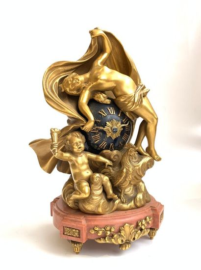 null A gilt bronze and black veined pink marble clock with allegorical decoration...