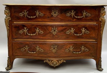 null A rosewood and amaranth veneered chest of drawers with a curved front opening...