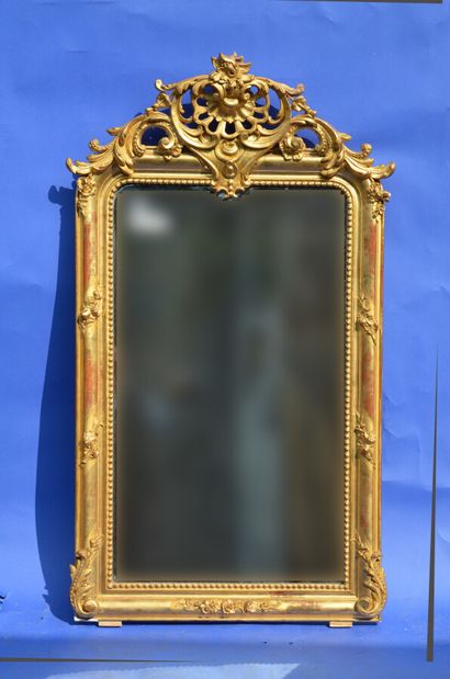 A wood and gilded stucco framed MIRROR decorated...