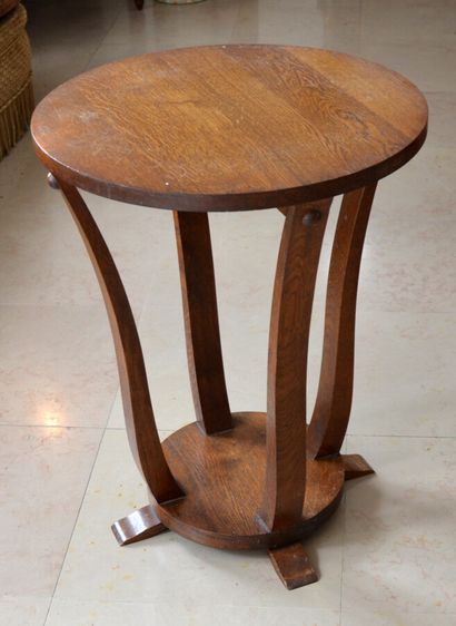 Natural wood pedestal table with four curved...