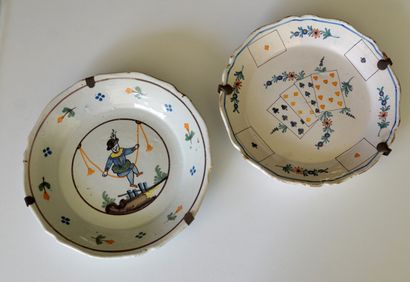 null Two earthenware plates decorated with cards or young man with scales

18th century

Diam....