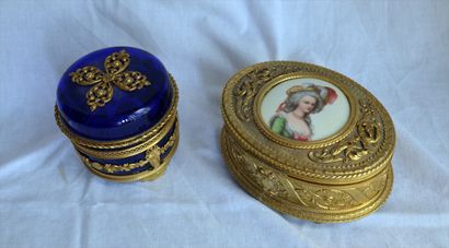 Two candy boxes: one oval in gilded metal,...
